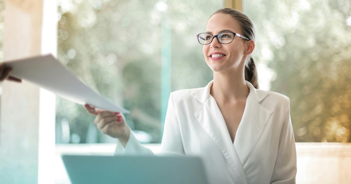 ecruitment consultant receiving candidate documents during an office meeting